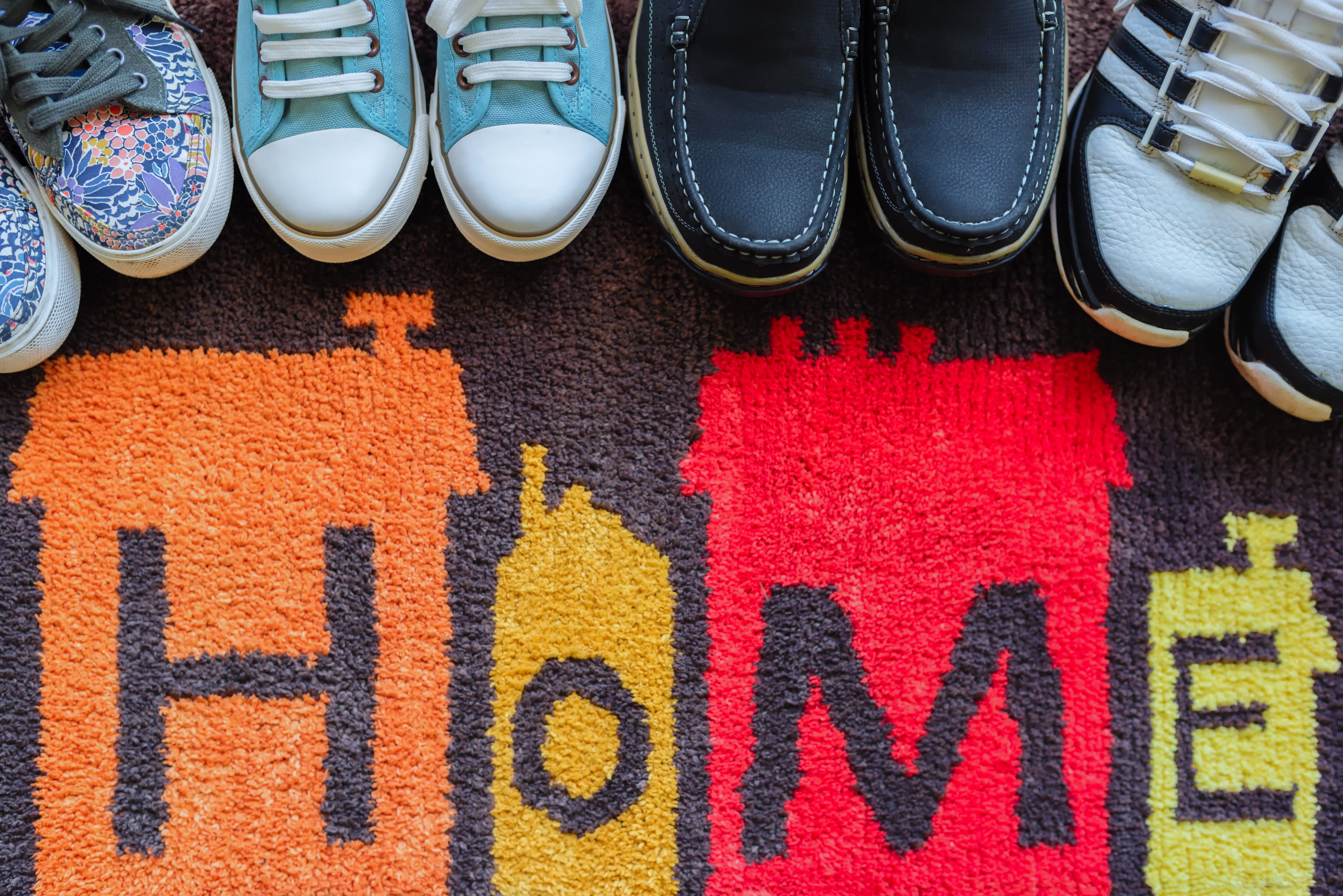 Welcome home carpet with shoes on it,welcome concept.